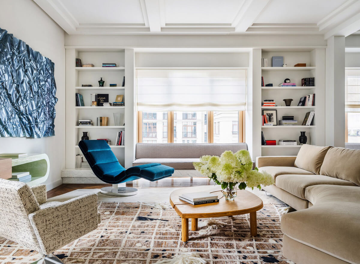 Інтер'єр квартири: простора вітальня з великим диваном та книжковою шафою для відпочинку.