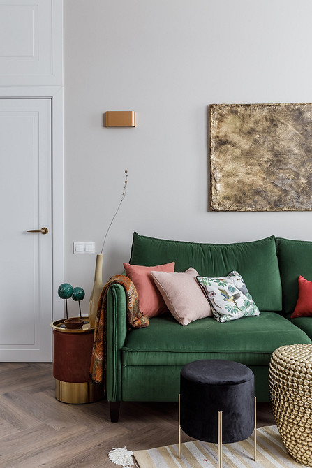 Невеликий журнальний столик-пуф у вітальні з диваном та декоративними подушками