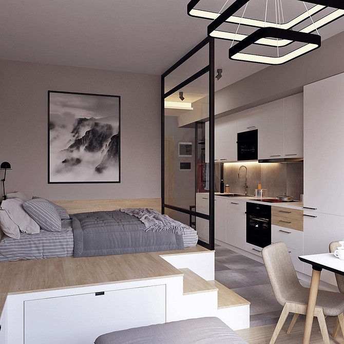 Подіум з вбудованими шухлядами для зберігання речей в малогабаритній квартирі.