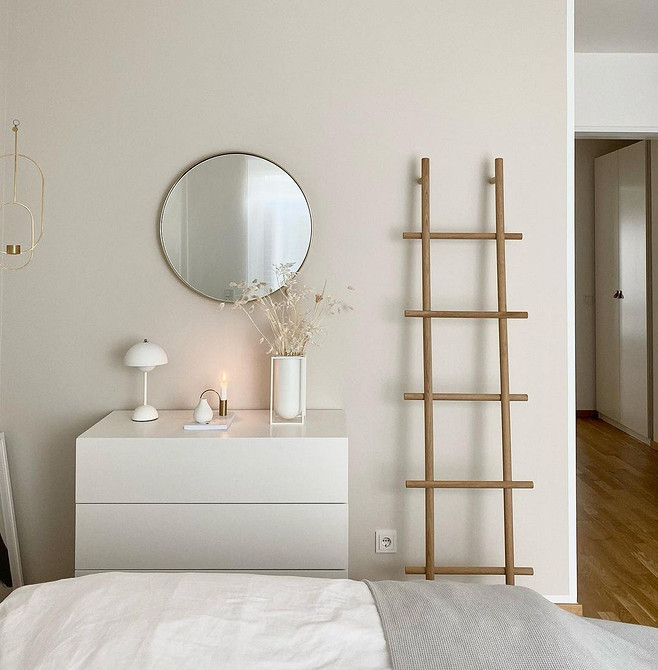 Інтер'єр спальні з білими меблями та текстилем у сірих тонах для спокійного дизайну