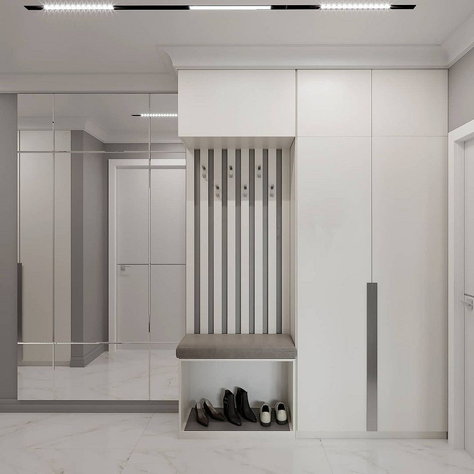 Інтер'єр спальні з білими меблями: ліжко, тумбочка та декор у світлих тонах.