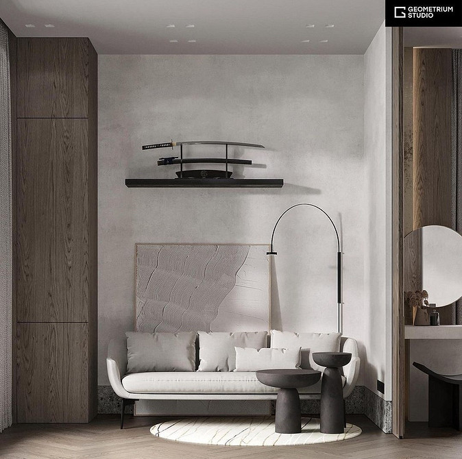 Білий велюровий диван з золотими ніжками у вітальні в стилі арт-деко.