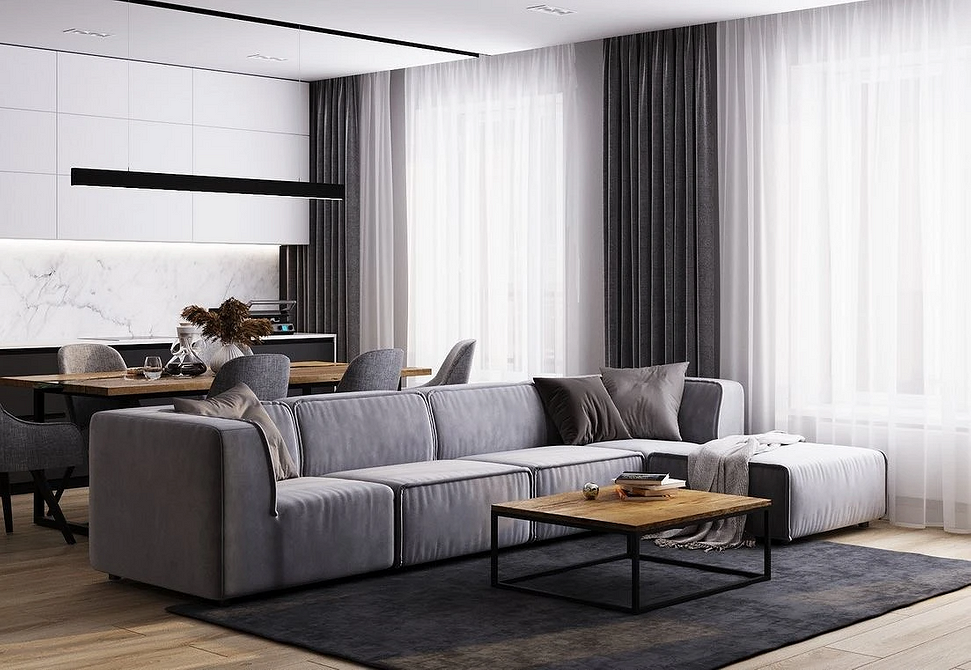 Функціональний диван у світлій вітальні, поєднання мінімалізму та практичності.