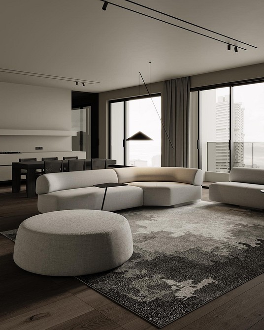 Вітальня з монохромним диваном та великим вікном, що забезпечує природне освітлення.