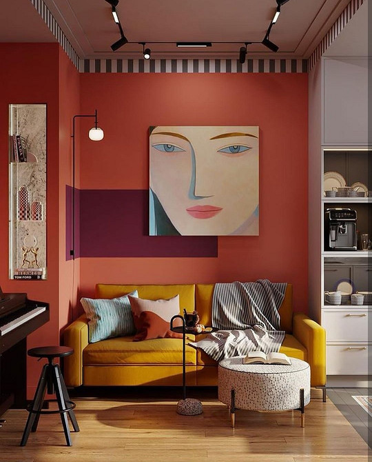 Невеликий диванчик на ніжках в скандинавському стилі з подушками.