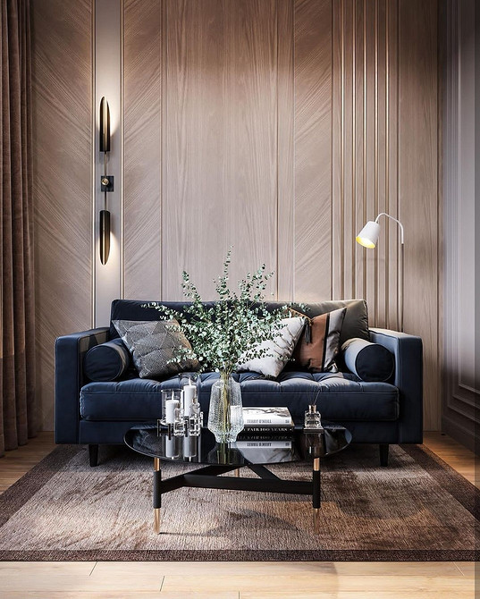 Диван з велюровою оббивкою на дерев'яних ніжках у затишній вітальні.