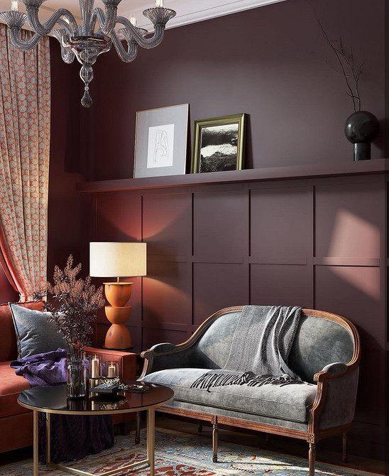 Диван з підлокітниками на витончених ніжках в елегантній вітальні.