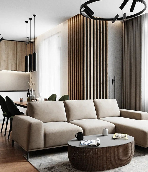 М'який кутовий диван на високих ніжках у світлому інтер'єрі, сучасний дизайн