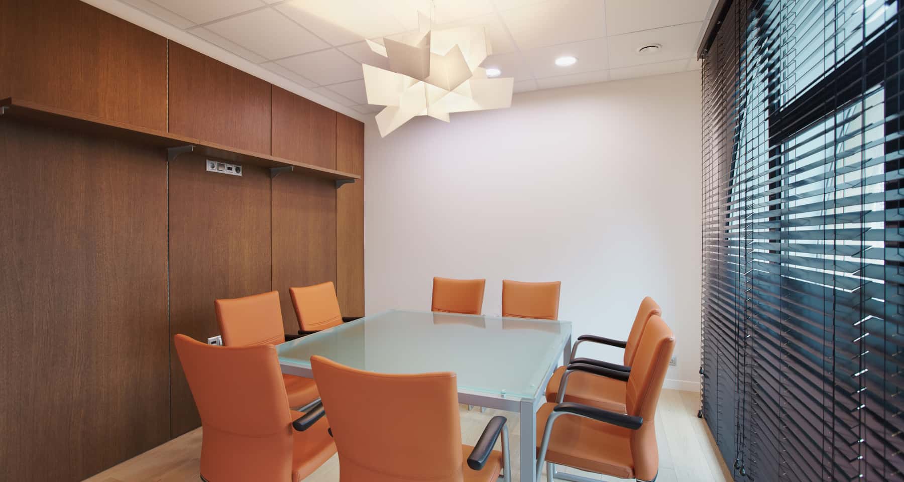Офісний інтер'єр: простір для переговорів з великим столом та зручними кріслами.