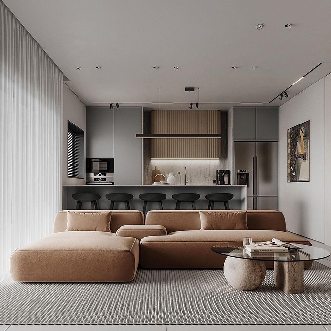 Двомісний коричневий диван в невеликій вітальні з книжковими полицями