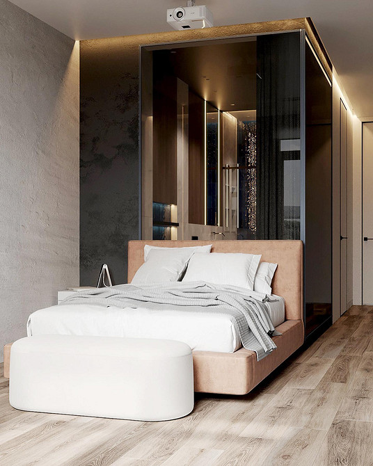 Сучасна спальня з ліжком з м'якою спинкою та декоративними подушками, що додають комфорту.