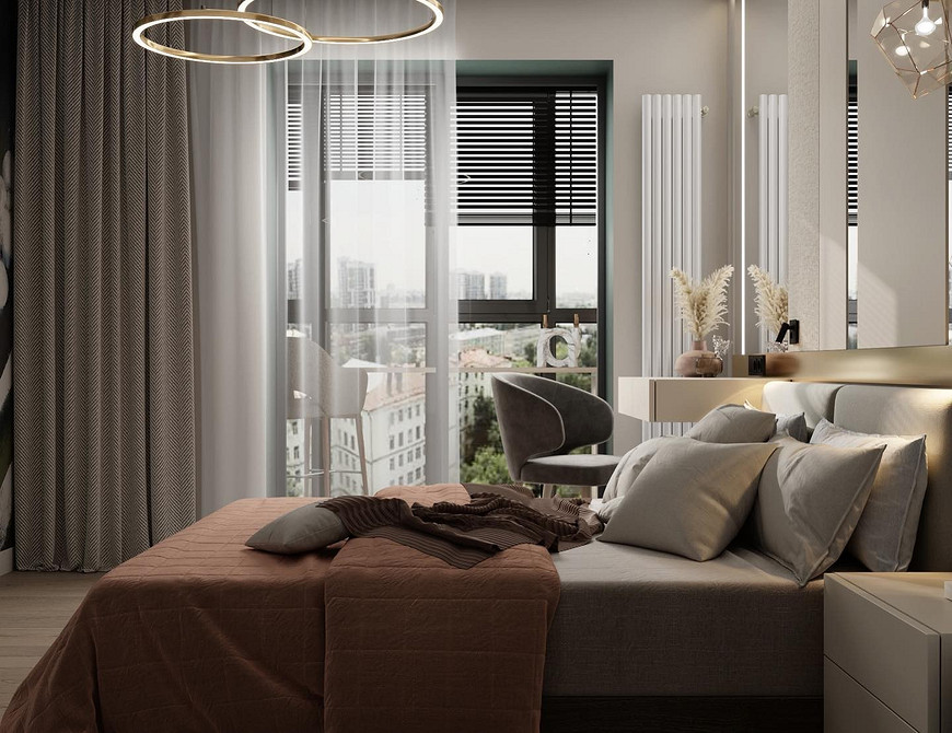 Інтер'єр спальні з ліжком з високим м'яким узголів'ям, тумбочками та лампами