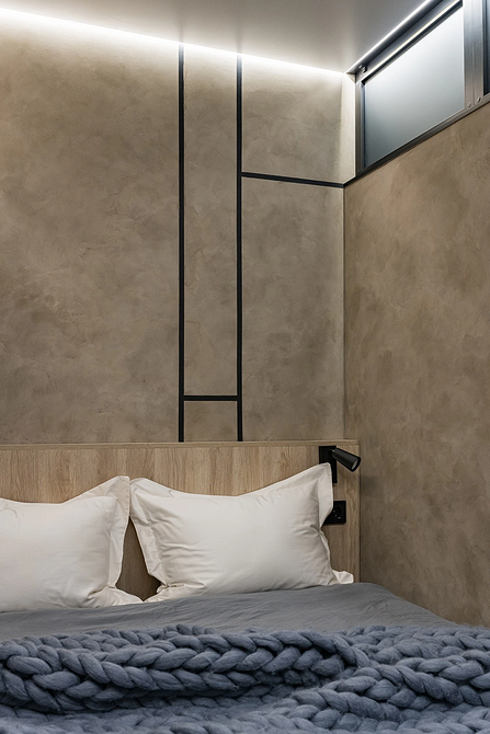 Нестандартне узголів'я ліжка з використанням металевих елементів в інтер'єрі спальні.