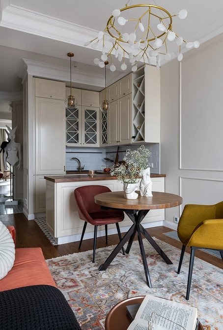 Елегантний обідній круглий стіл з білою стільницею і чорними ніжками