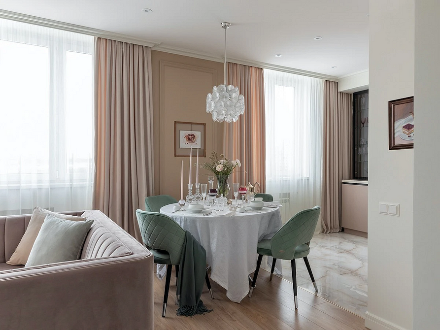 Стильний круглий стіл з металевими ніжками в сучасному інтер'єрі квартири