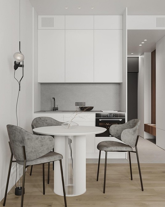 Сучасна кухня з великим круглим столом, ідеальне рішення для великої родини та обідньої зони.