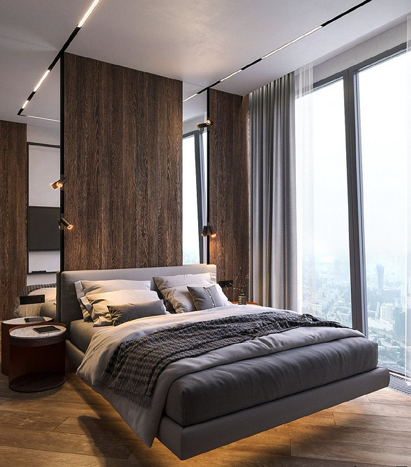 Спальня з парячим ліжком, розташованим біля великого вікна з видом на місто.