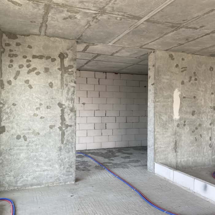 Бетонні стіни квартири в новобудові без обробки, підготовка до дизайну.