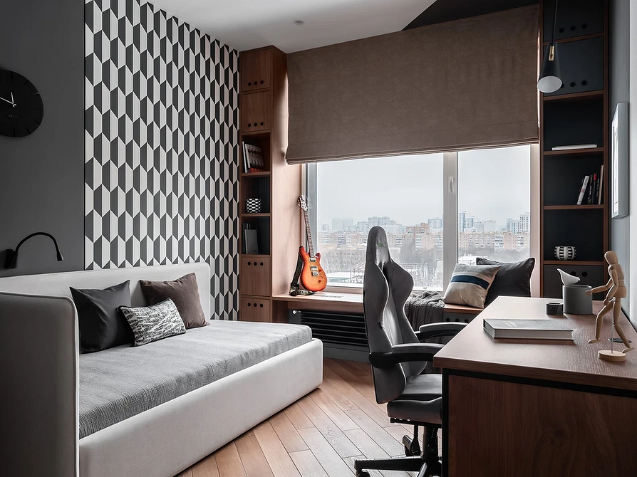 Дизайн спальні з сірим ліжком та акцентною стіною, що створює затишок.