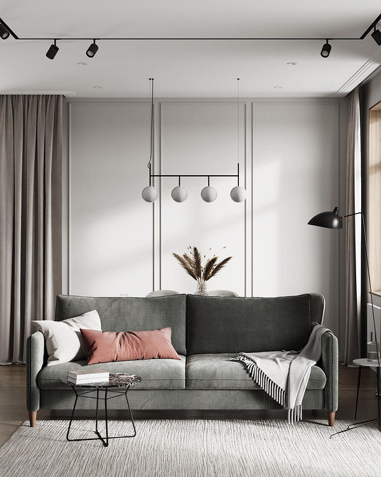 Сіра м'яка мебель у вітальні з яскравими подушками: стильний акцент в інтер'єрі.