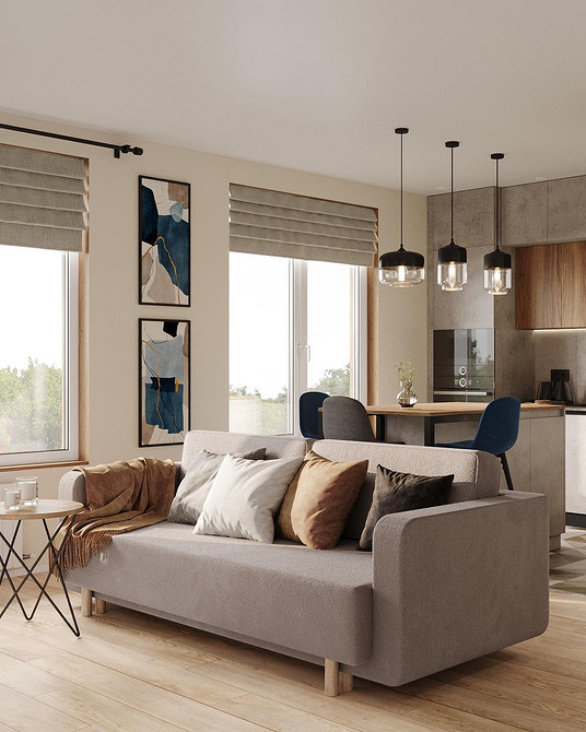 Дизайн вітальні з сірим диваном та рослинами в горщиках для затишку.