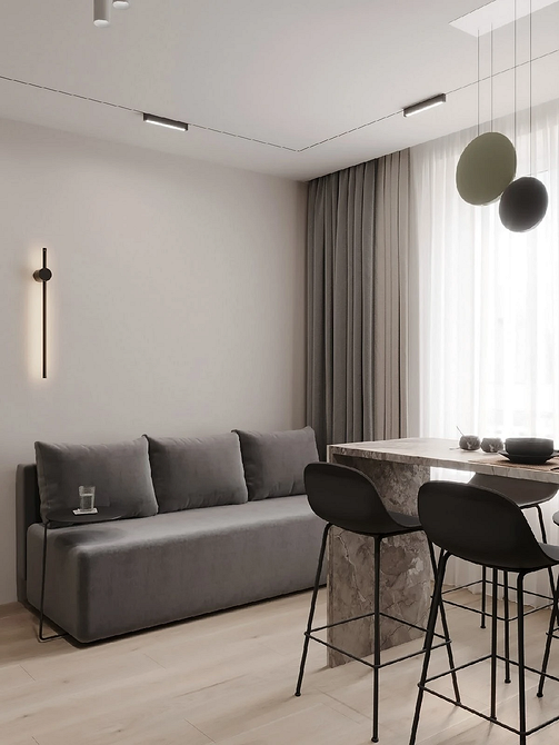 Сірий шкіряний диван у сучасному офісному приміщенні з панорамними вікнами.