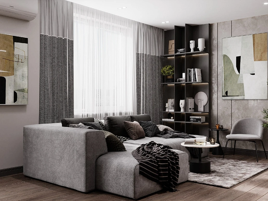 Інтер'єр вітальні з сірим диваном, килимом з геометричним малюнком та зеленими рослинами