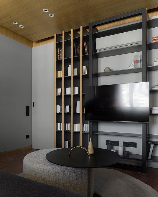 Кутова шафа для вітальні з місцем під телевізор та додатковими полицями.