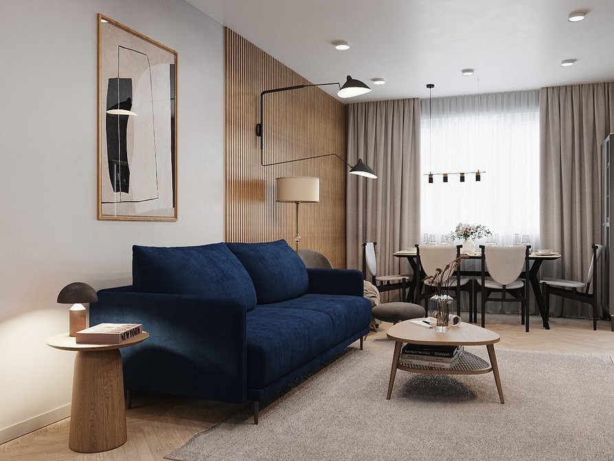 Стильний дизайн вітальні з синім диваном, килимом та дерев'яним столиком