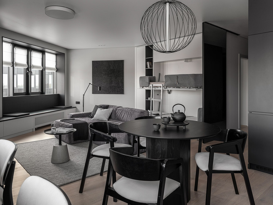 Кухня-вітальня з кутовим диваном, що зонує простір та додає комфорту.