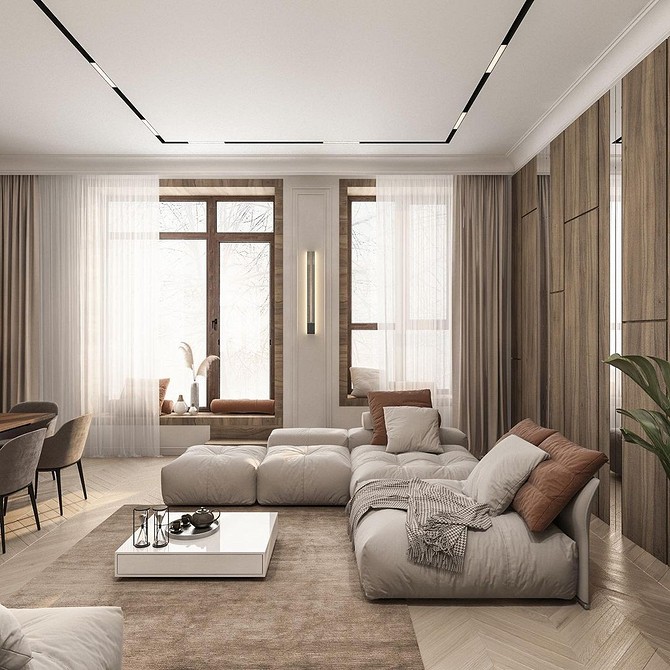 Великий кутовий диван з подушками у просторій вітальні з панорамними вікнами