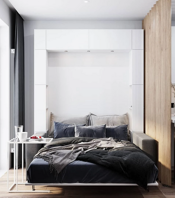 Сучасна спальня з великим ліжком та м'яким узголів'ям для комфортного сну.