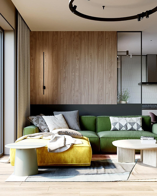 Зелений диван в інтер'єрі з використанням текстилю та декоративних подушок для затишку.