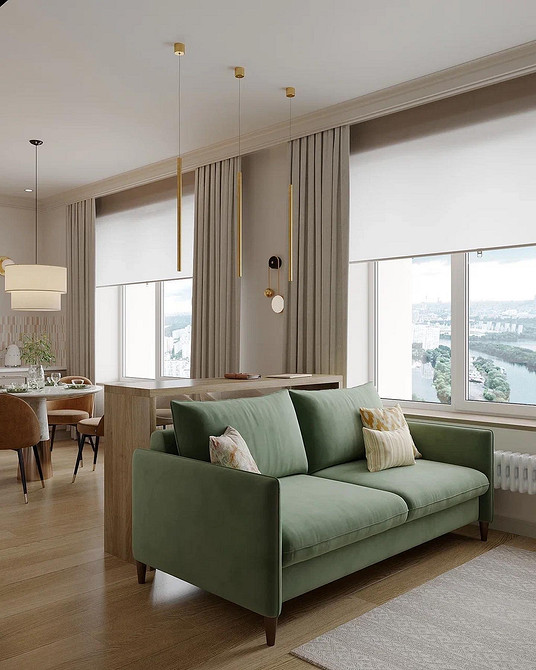 Зелений диван у вітальні з декоративними подушками та текстилем для затишку