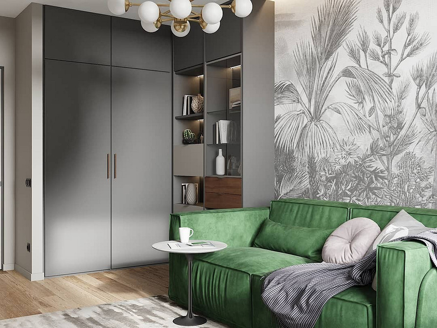 Зелений диван з велюровою оббивкою в інтер'єрі вітальні, поєднання з сірим