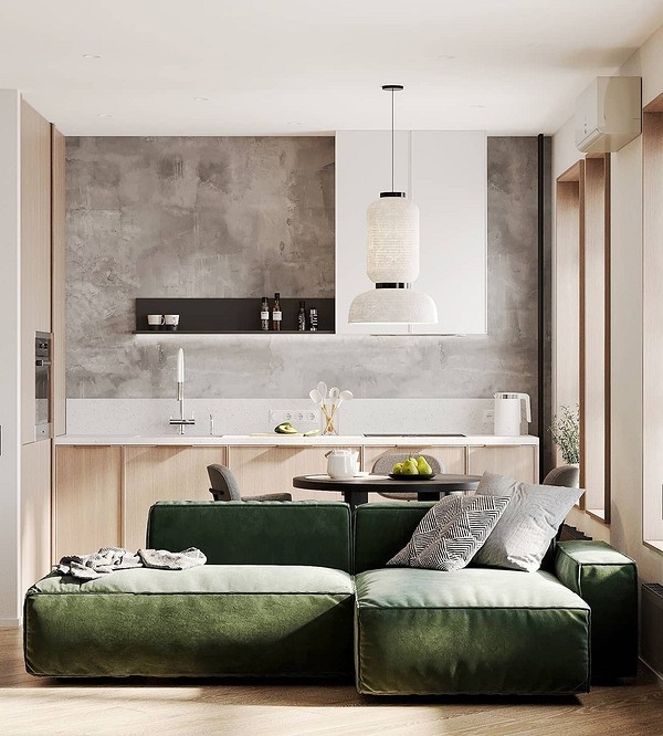 Зручний зелений диван з декоративними подушками та пледом в інтер'єрі