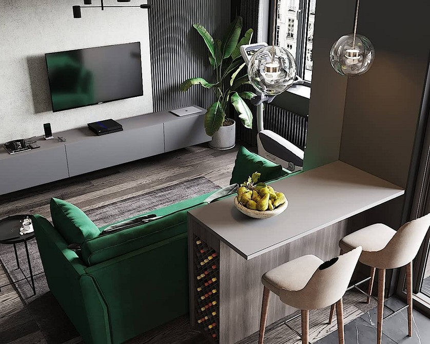 Невеликий зелений диванчик у вітальні з яскравими акцентами жовтого та синього.